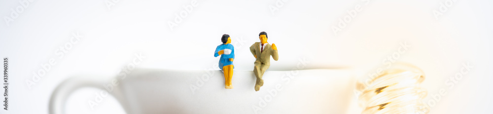 Miniature people: Business team sitting on cup of coffee with copy space using as background business cover page concept. Miniature people: Business team sitting on cup of coffee with copy space using as background business cover page concept.