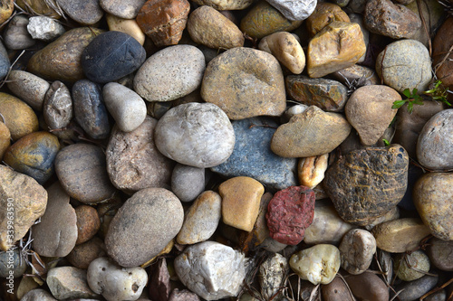 A scattering of multi-colored stones. Pebble background texture