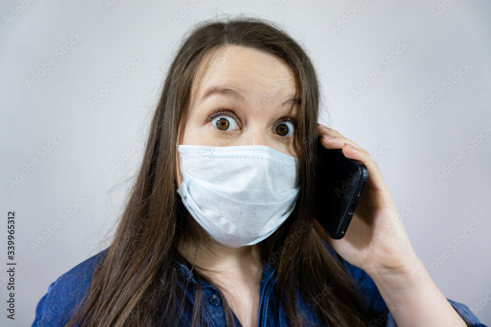 woman in medical mask doing phone call, stay home during self isolation and quarantine at corona virus, covid-19 woman in medical mask doing phone call, stay home during self isolation and quarantine at corona virus, covid-19