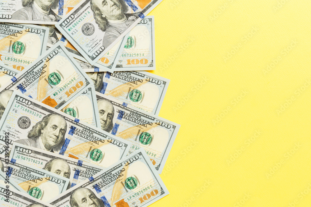 Top view banknotes on colored desk with copy space on top. one hundred dollar bills with stack of money in the middle. Top view of business concept Top view banknotes on colored desk with copy space on top. one hundred dollar bills with stack of money in the middle. Top view of business concept