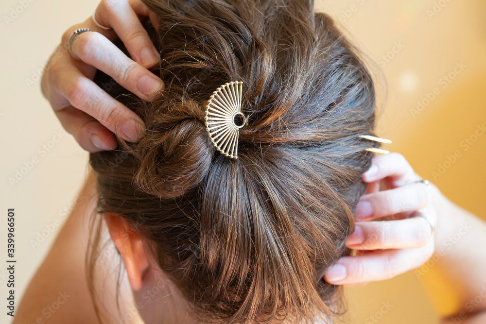 Fototapeta premium Woman wearing metal hair pin in her hair bin
