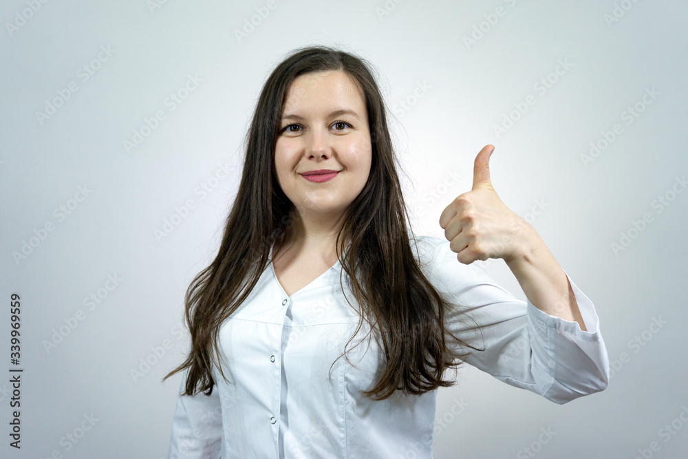Smiling female medicine doctor showing ok sign with thumb up Smiling female medicine doctor showing ok sign with thumb up