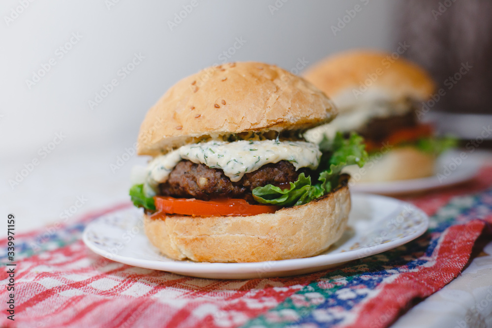 Small homemade burgers lie on a plate. juicy photo with blur closeup Small homemade burgers lie on a plate. juicy photo with blur closeup