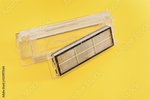 filter for robot vacuum cleaner on yellow background, copy space