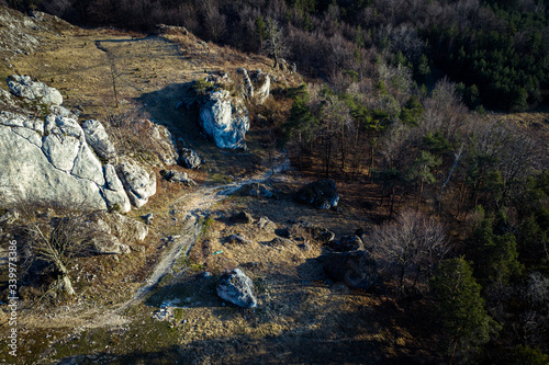 Top down view/ Aerial view over limestone rocks on the Mountain Kołoczek in Podlesice (Upland Cracow - Czestochowa, Wyzyna Krakowsko - Czestochowska), popular tourist place. During sunny early spring 