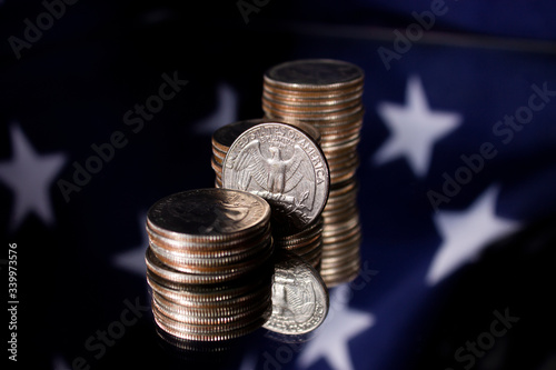 stacks of american dollar coins on US flag background