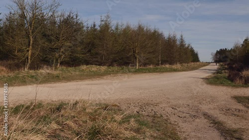 Man Mountain Biking down a gravel track in the countryside