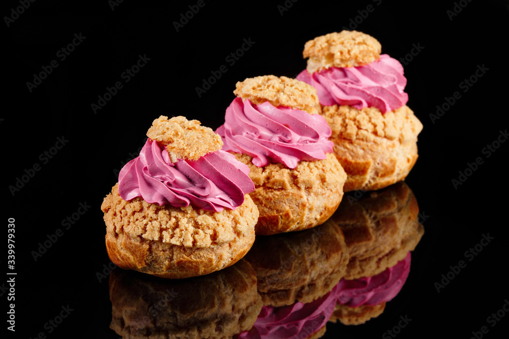 Cream CHOUX dessert. Set of 3 pieces. Black background with reflection. Art of pastry Cream CHOUX dessert. Set of 3 pieces. Black background with reflection. Art of pastry