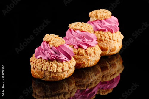 Cream CHOUX dessert. Set of 3 pieces. Black background with reflection. Art of pastry