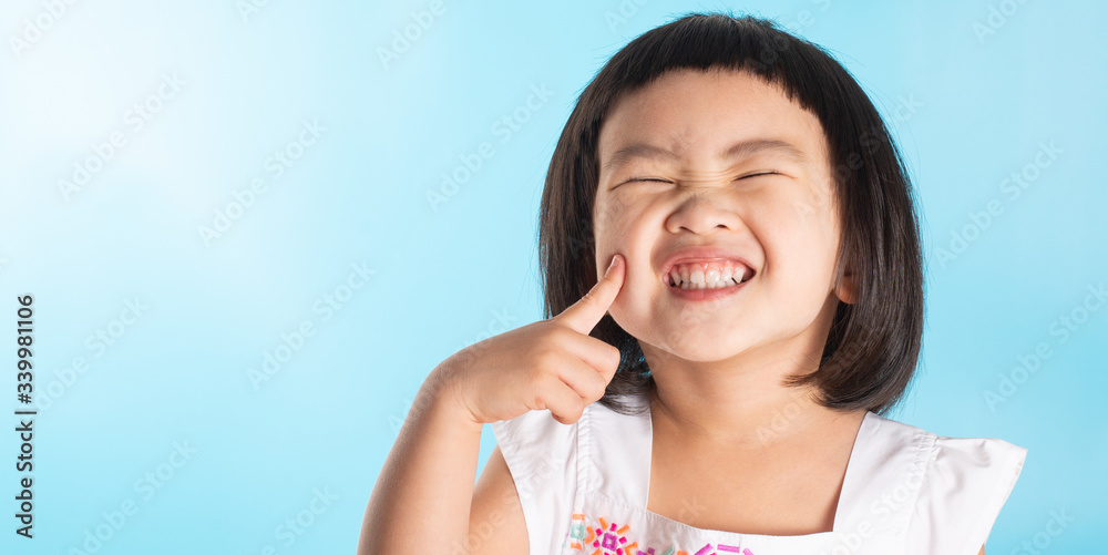 Happy asian cute girl on blue background. Happy asian cute girl on blue background.