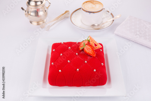 Cake red velvet with strawberries and silver caramel balls photo