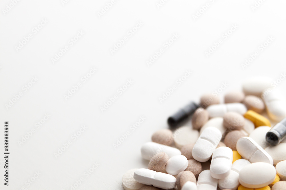 Pile of pills isolated on white background. Copy space.