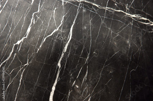 A slab of natural marble, black with white stripes veins, called Nero Marquina