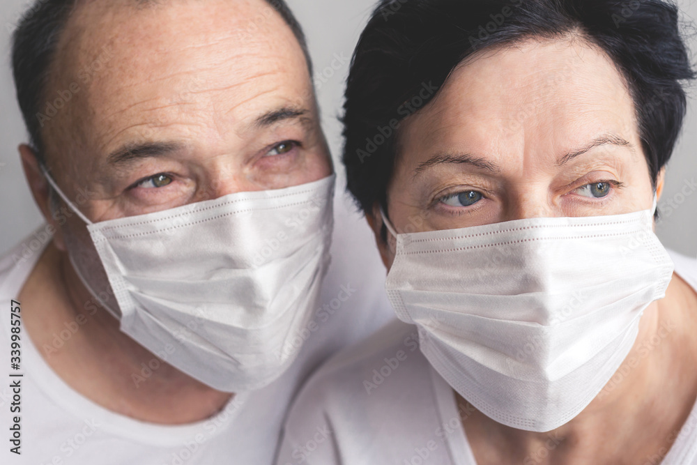 Seniors man and woman in medical masks close up of faces Wearing medical mask to prevent coronavirus covid-19