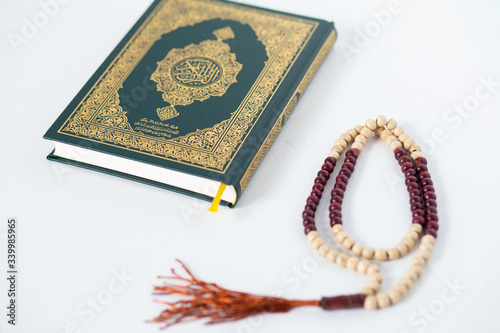 Quran - holy book of Muslims religion, Concept: open book holy prayers for god, Friday In the month of Ramadan religion Islamic worshiping faith and learn koran and rosary put on wooden boards 