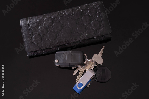 purse and car keys and house keys lie on a table