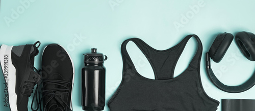Black color fitness accessories set on pink background.