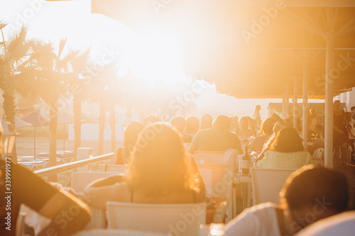 Fototapeta Naklejka Na Ścianę i Meble -  07.07.2018 Istanbul, Turkey: Waiters Serving Guests at Tables at a Beach Restaurant Near Hotel in Turkey at Sunset
