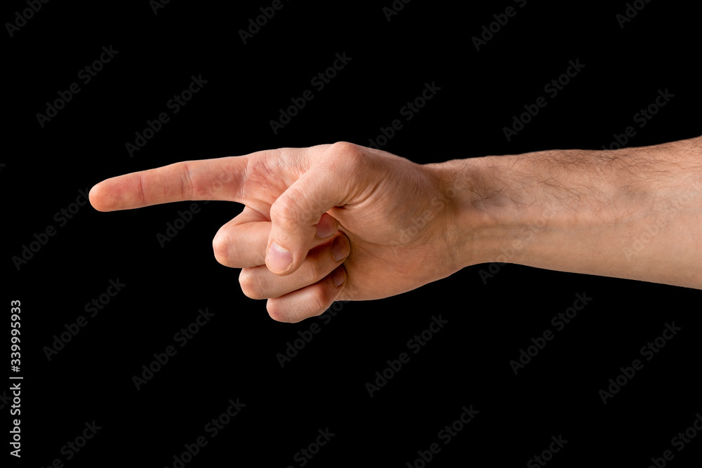The male hand points a finger at an object on a white background. Symbol of choice. Hand with fingers in a gun. Separate on a black background. Symbolizes the shooting of someone in the head. The male hand points a finger at an object on a white background. Symbol of choice. Hand with fingers in a gun. Separate on a black background. Symbolizes the shooting of someone in the head.