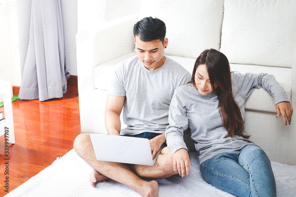 Asian couples sitting and working at home To prevent the problem of viral infection from people. Concept of risk reduction In coronavirus infection according to government policy Asian couples sitting and working at home To prevent the problem of viral infection from people. Concept of risk reduction In coronavirus infection according to government policy