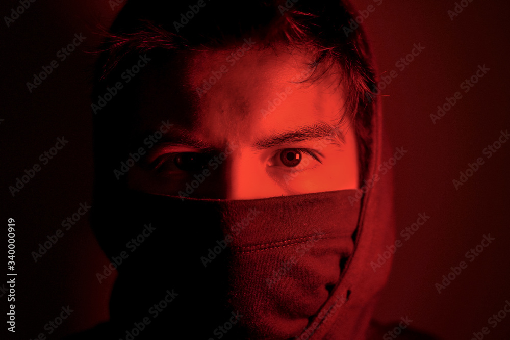 Young man with mask in red light in times of pandemic Young man with mask in red light in times of pandemic