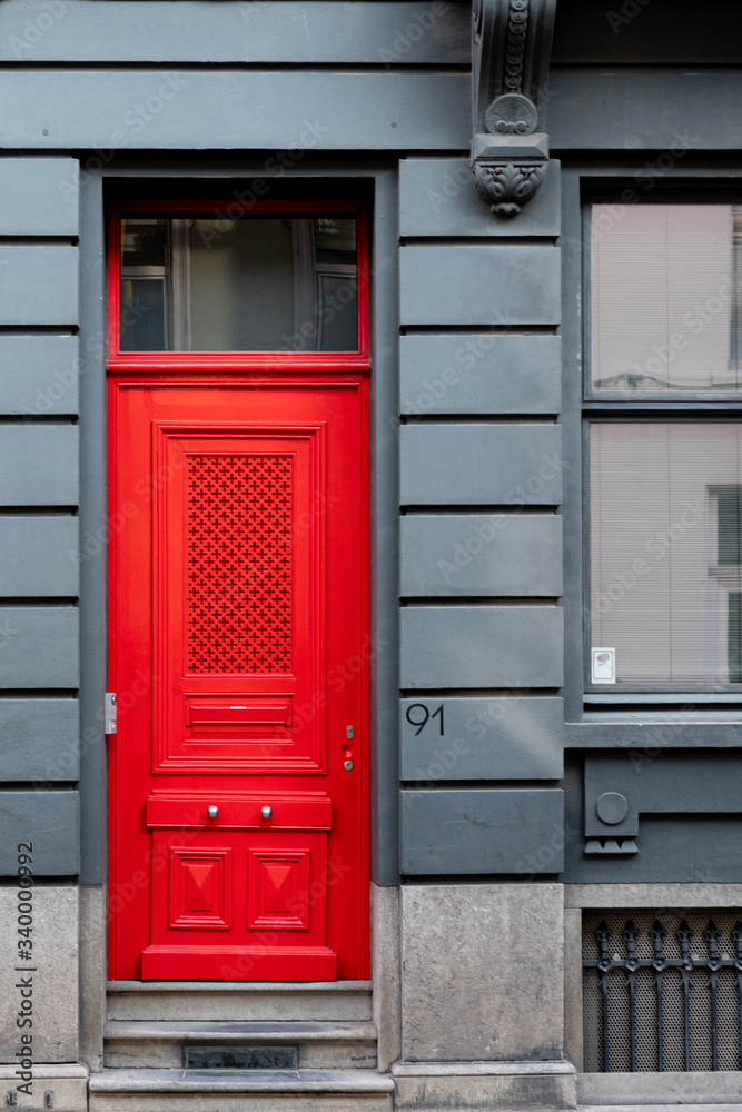 gray facade with red door gray facade with red door