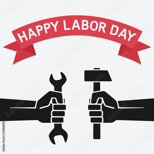 Happy labor day concept. Hands holding hammer and wrench on vintage background