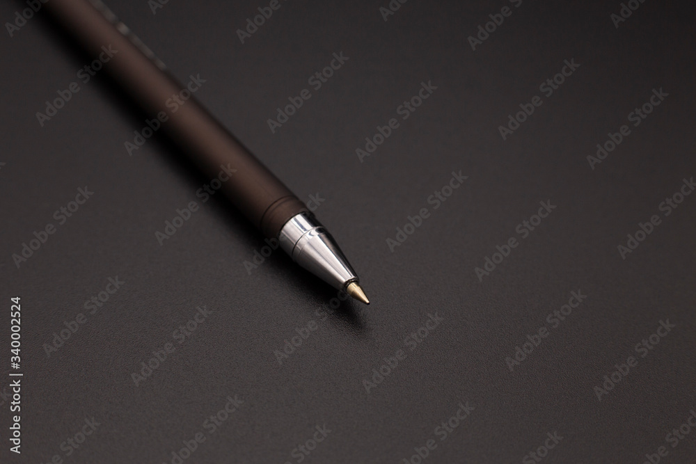 Stylish black fountain pen on a dark background Stylish black fountain pen on a dark background