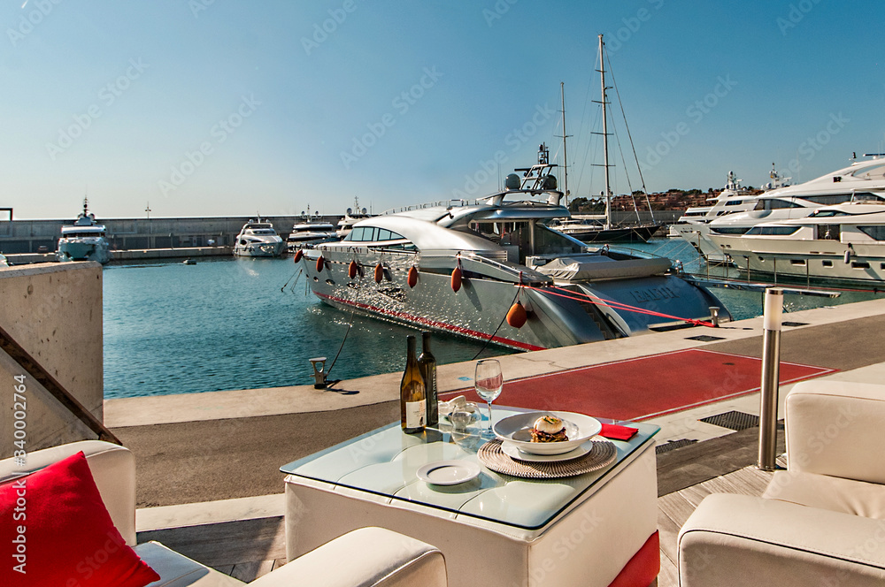 Fototapeta premium Mediterranean food on the terrace of a restaurant in a marina.