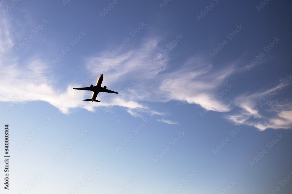 Airplane on a background of blue sky. The plane is landing. The plane takes off. Airplane on a background of blue sky. The plane is landing. The plane takes off.
