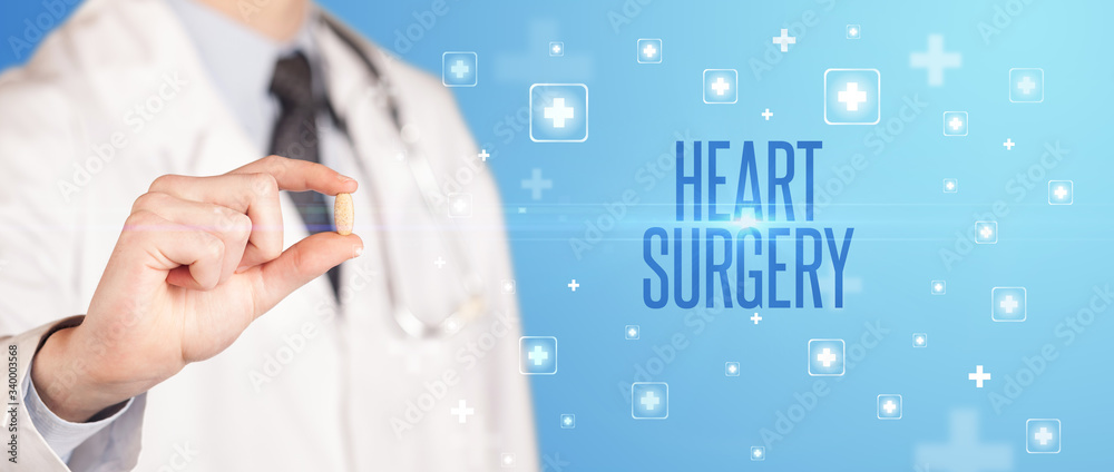 Close-up of a doctor giving a pill with HEART SURGERY inscription, medical concept Close-up of a doctor giving a pill with HEART SURGERY inscription, medical concept