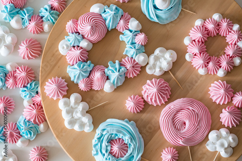 blue and pink meringues on wooden table