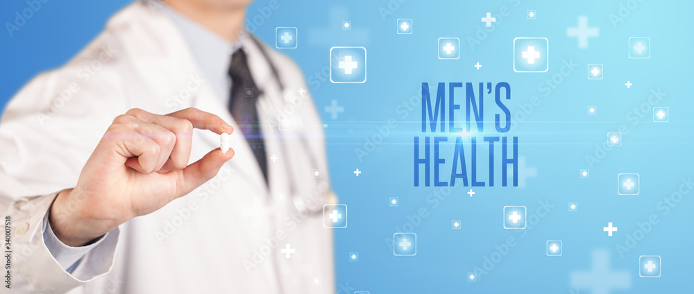 Close-up of a doctor giving a pill with MEN’S HEALTH inscription, medical concept Close-up of a doctor giving a pill with MEN’S HEALTH inscription, medical concept