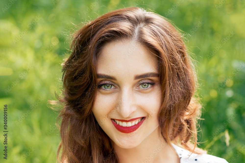 Portrait of beautiful young smiling woman on green summer background. Portrait of beautiful young smiling woman on green summer background.