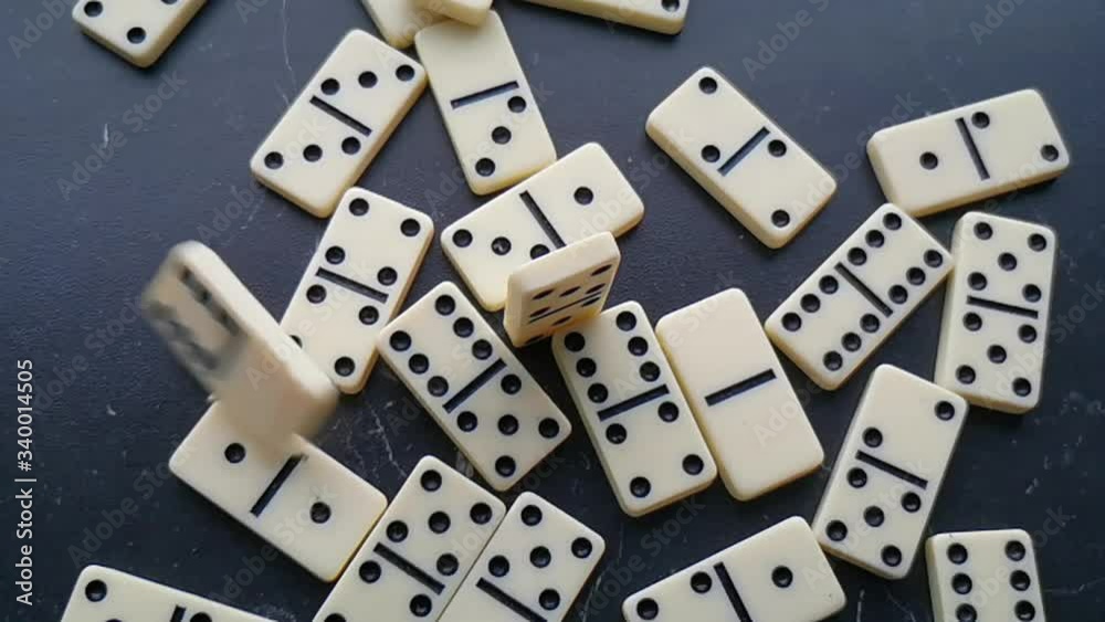 white dominoes with black dots on a dark background white dominoes with black dots on a dark background