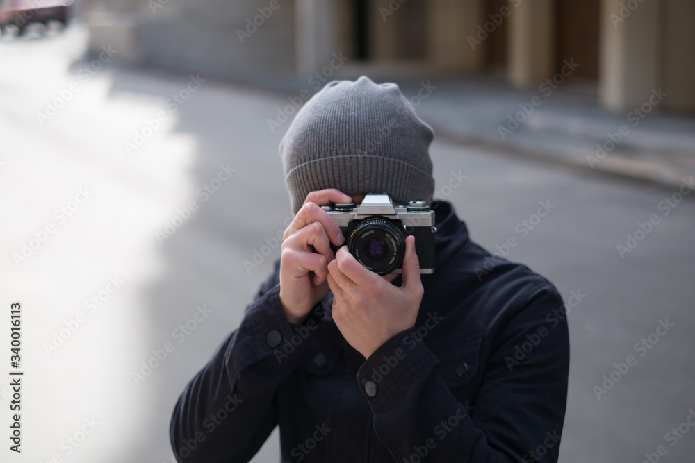 thoughtful male photographer with a camera on street thoughtful male photographer with a camera on street