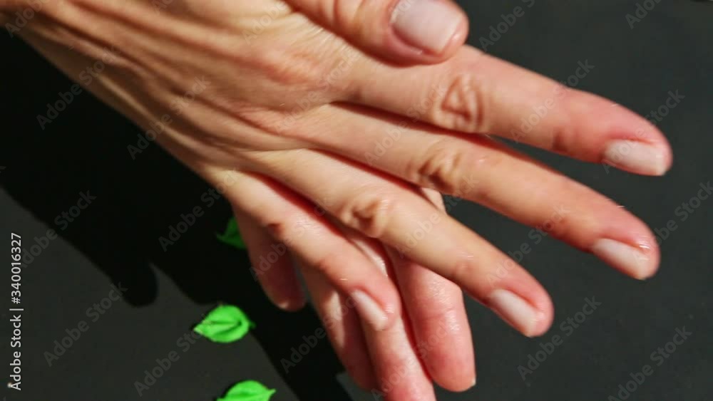 top view closeup on female hands form small marzipan peach colored ball top view closeup on female hands form small marzipan peach colored ball