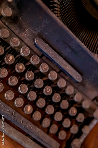 keyboard layout on a dusty black antique typewriter on the table