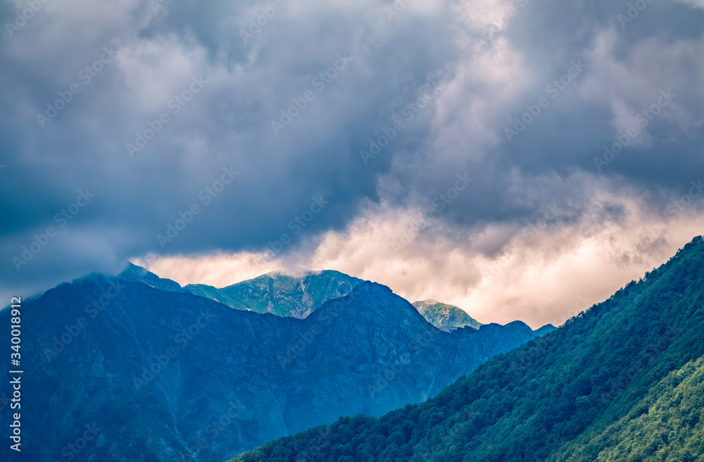 Green mountains on a background of cloudy sunset.