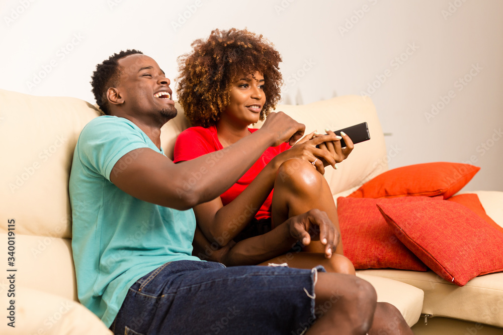 Black African American couple watching tv in the living room Stock ...