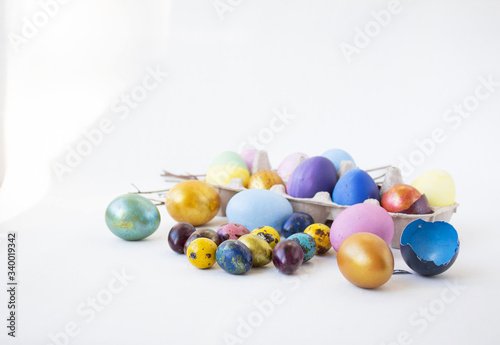 On a white background are painted eggs. Real hand-painted eggs. A multi-faceted photo. Holiday and joy of Bright Easter for the whole family