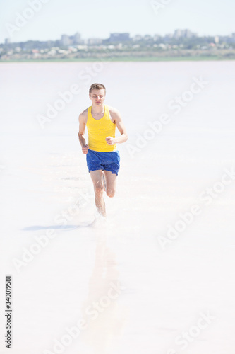 Man running in water on the beach