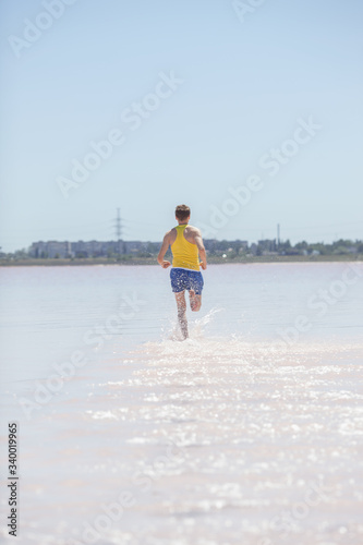 Man running in water on the beach