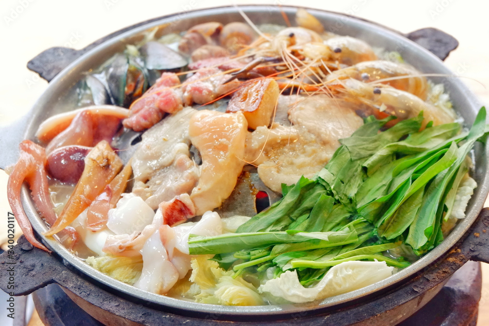 Sliced Pork and seafood on Thai Styled Coal Grill and Shabu Pan.Shrimp Clams in a Hot Pan.Close up.
Sliced Pork and seafood on Thai Styled Coal Grill and Shabu Pan.Shrimp Clams in a Hot Pan.Close up.