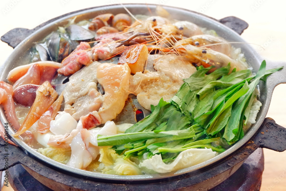 Sliced Pork and seafood on Thai Styled Coal Grill and Shabu Pan.Shrimp Clams in a Hot Pan.Close up.
Sliced Pork and seafood on Thai Styled Coal Grill and Shabu Pan.Shrimp Clams in a Hot Pan.Close up.