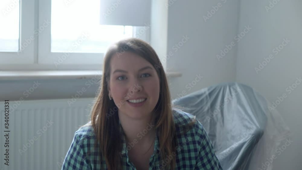 Moving into a new home. A woman carries a box cardboard, apartment owner
