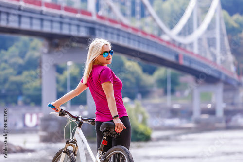 Woman ride bike on the summer road, Activities for keeping healthy, Concept of recreation