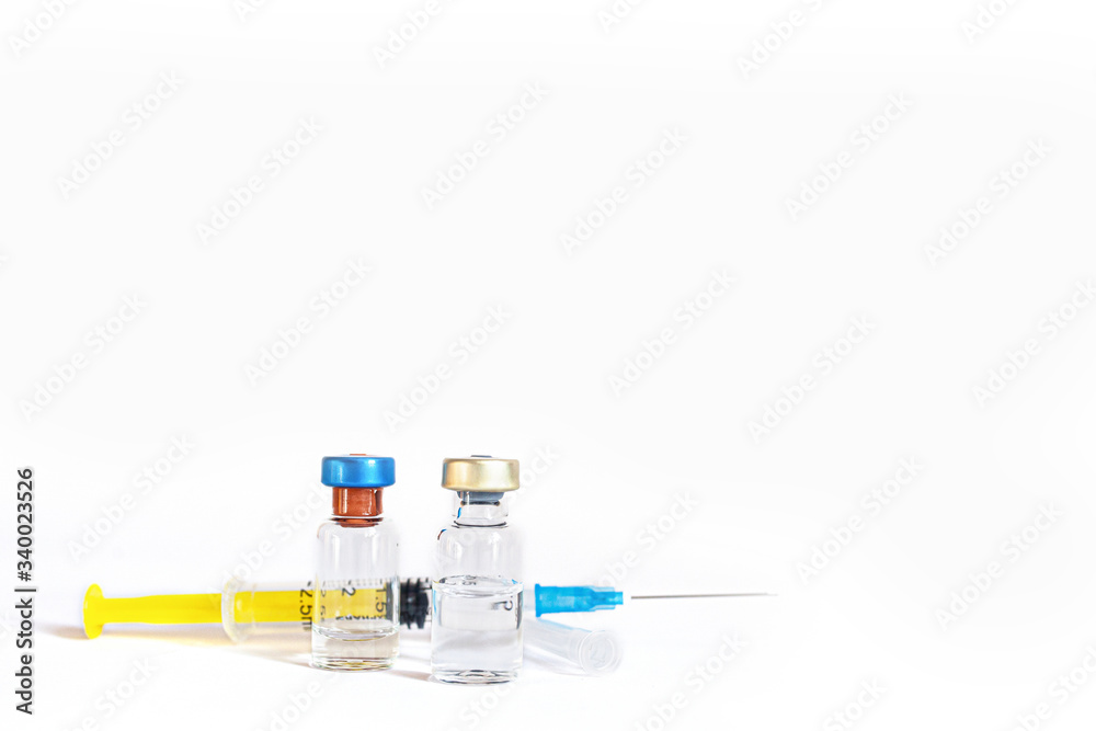 Syringe and vaccine bottles isolated on white Syringe and vaccine bottles isolated on white