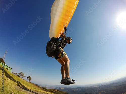 man launching with extreme paraglider photo