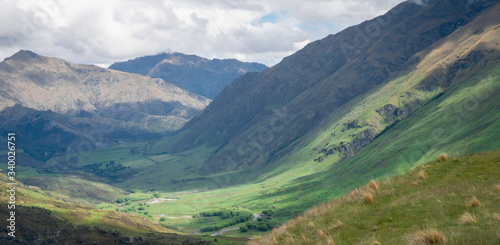 Lush green valley panoramic landscape shot made during overcast day in New Zealand